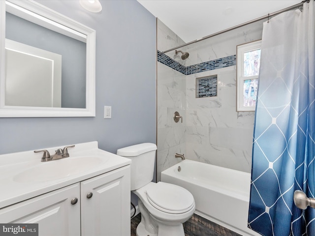 full bathroom featuring shower / tub combo with curtain, vanity, and toilet