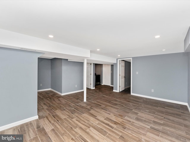 basement with hardwood / wood-style flooring