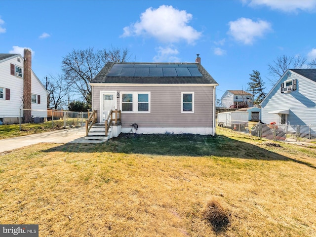 bungalow-style house with a front lawn and solar panels