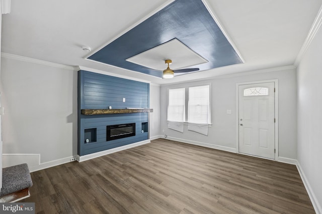 unfurnished living room with crown molding, a raised ceiling, hardwood / wood-style flooring, ceiling fan, and a fireplace