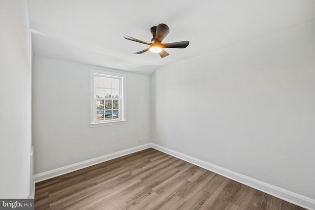 unfurnished room with hardwood / wood-style flooring, lofted ceiling, and ceiling fan