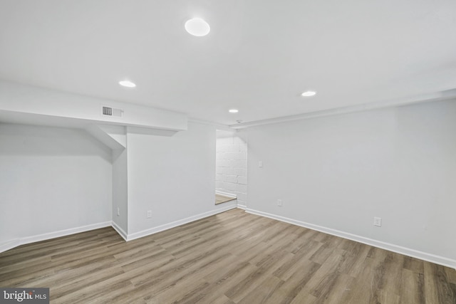 basement featuring hardwood / wood-style floors