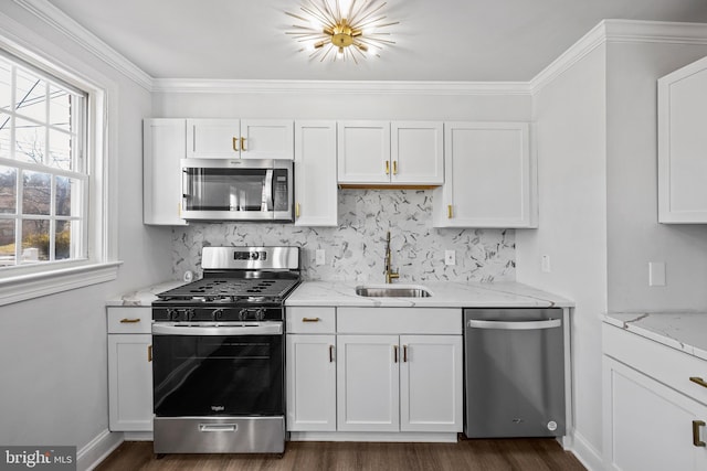 kitchen with backsplash, stainless steel appliances, sink, and white cabinets