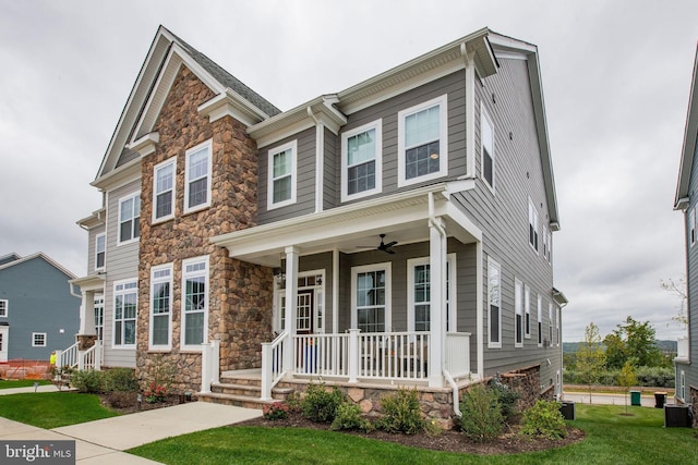 view of front of home with a porch, central air condition unit, and a front lawn