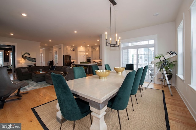 dining area featuring a chandelier and light wood-type flooring