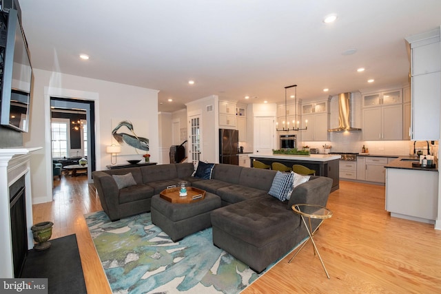 living room with sink and light hardwood / wood-style floors