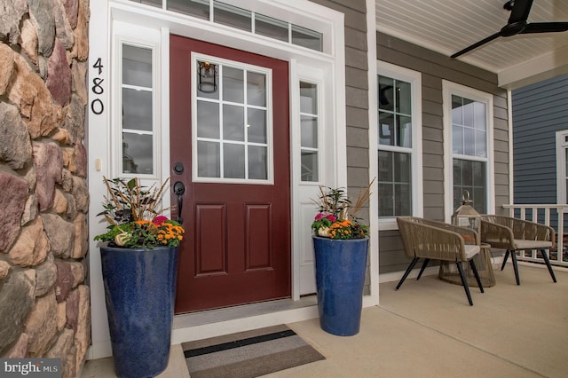 entrance to property featuring ceiling fan and covered porch