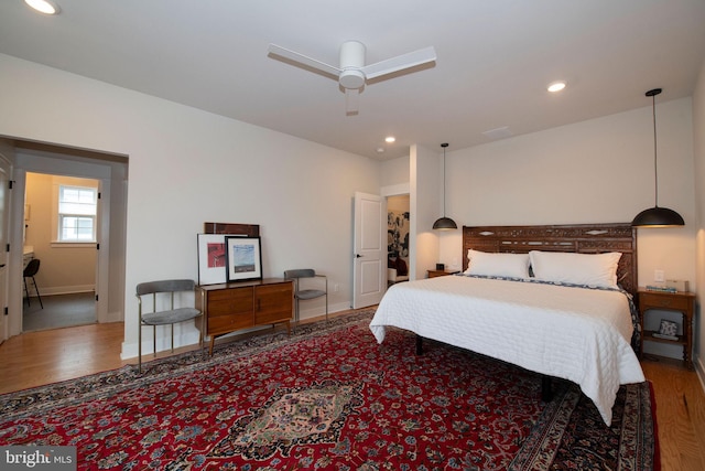 bedroom with hardwood / wood-style flooring and ceiling fan