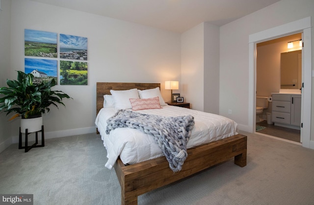 bedroom with carpet flooring and connected bathroom