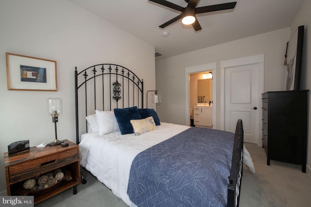 bedroom with connected bathroom, ceiling fan, and carpet flooring