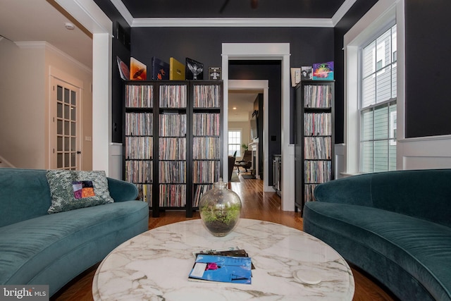 living room with crown molding and hardwood / wood-style floors