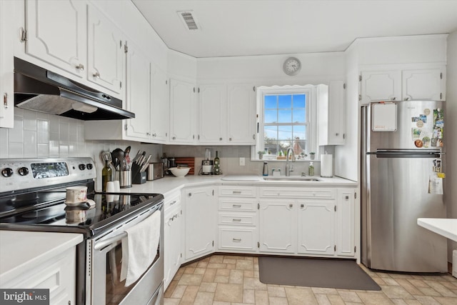 kitchen featuring sink, decorative backsplash, white cabinets, and appliances with stainless steel finishes