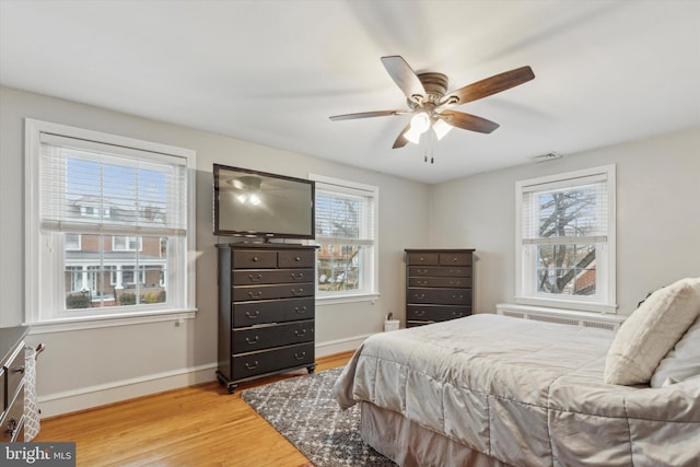 bedroom with ceiling fan and light wood-type flooring