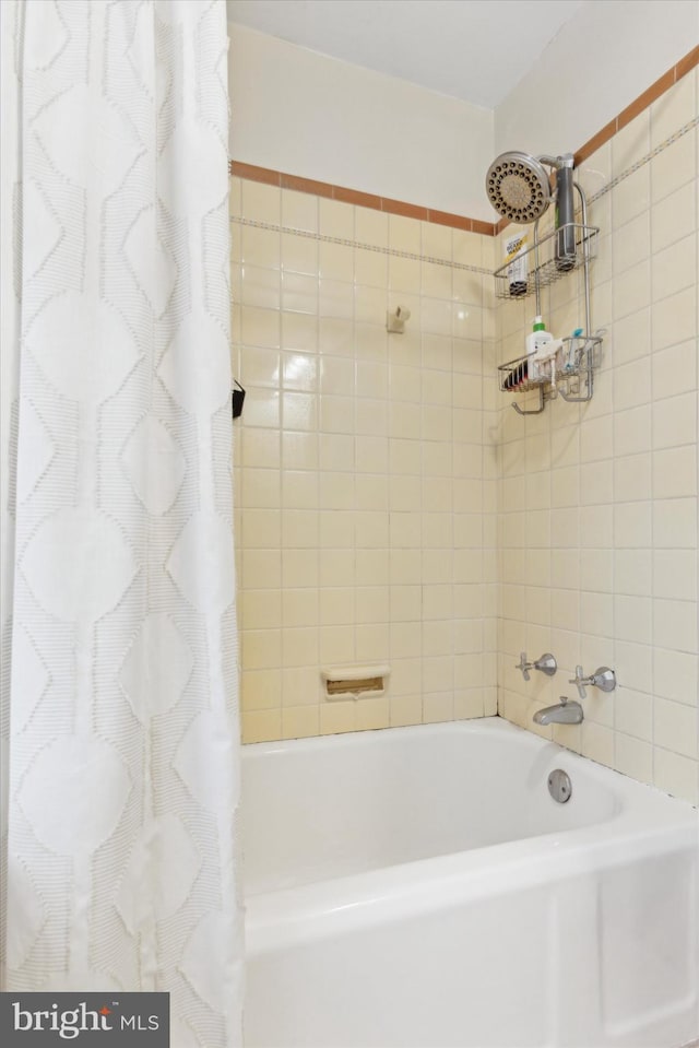 bathroom with shower / bath combination with curtain