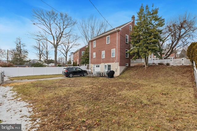 view of side of property with a lawn