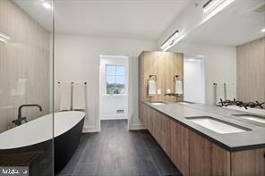 bathroom with vanity, hardwood / wood-style floors, and a tub