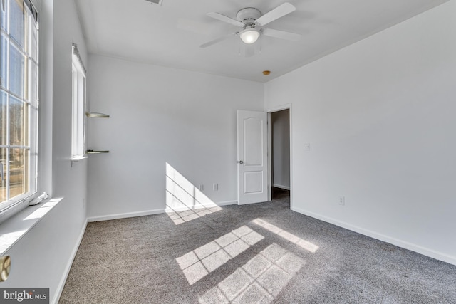 unfurnished bedroom with ceiling fan, baseboards, and carpet flooring