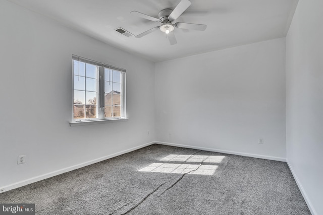 spare room featuring a ceiling fan, baseboards, visible vents, and carpet flooring