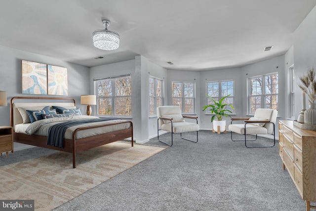 carpeted bedroom with visible vents and baseboards