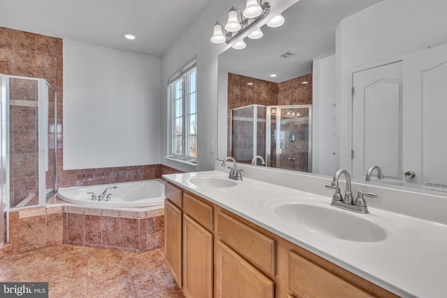 full bathroom featuring a bath, a shower stall, visible vents, and a sink