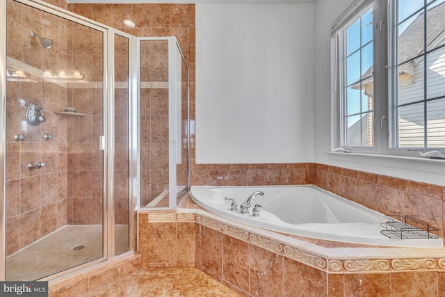 full bathroom featuring a garden tub and a shower stall