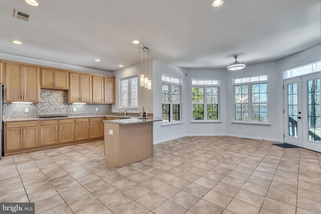 kitchen with appliances with stainless steel finishes, visible vents, decorative backsplash, and french doors