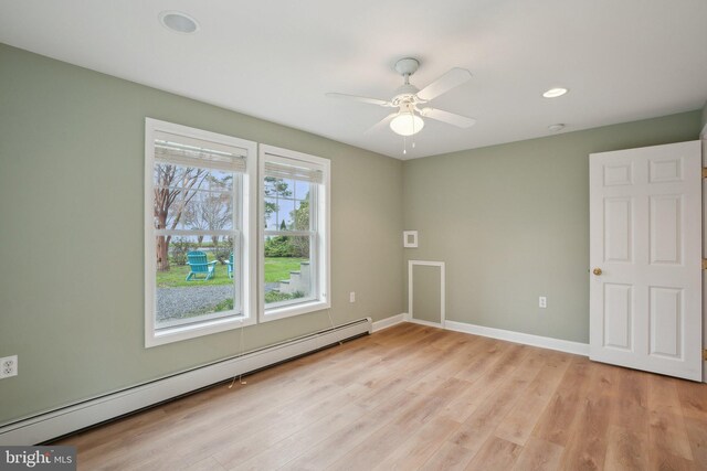 empty room with a ceiling fan, baseboard heating, baseboards, light wood finished floors, and recessed lighting