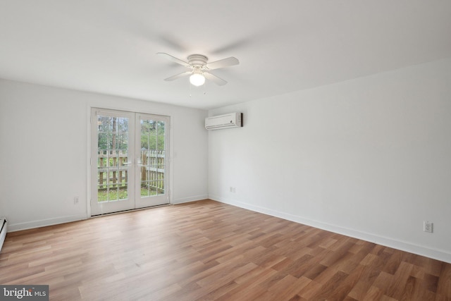 unfurnished room featuring light wood-style floors, a wall mounted air conditioner, baseboards, and ceiling fan
