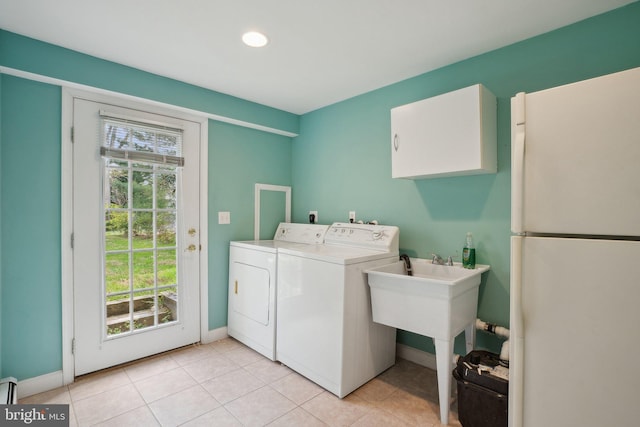 laundry room with cabinet space, recessed lighting, baseboards, light tile patterned floors, and washer and clothes dryer