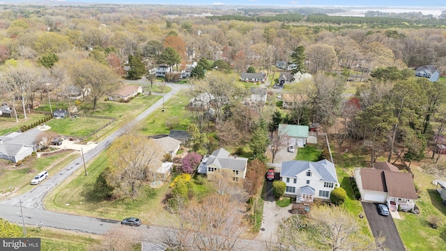 bird's eye view featuring a residential view and a wooded view