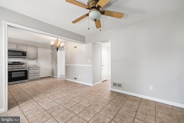 interior space with gray cabinetry, light tile patterned floors, ceiling fan with notable chandelier, and appliances with stainless steel finishes