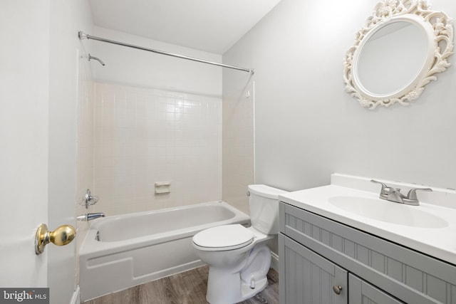 full bathroom featuring vanity, hardwood / wood-style floors, shower / tub combination, and toilet