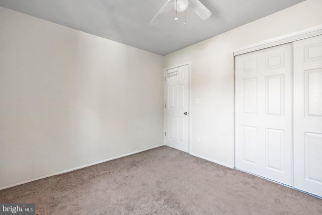 unfurnished bedroom featuring light carpet and ceiling fan