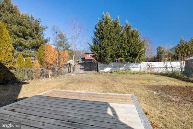 wooden deck featuring a yard