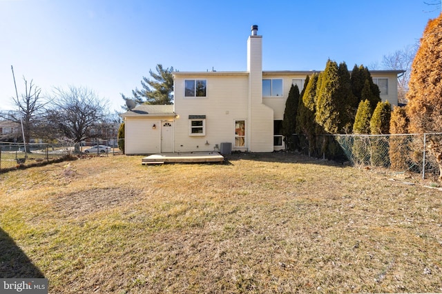 back of house featuring a wooden deck, a yard, and central AC unit