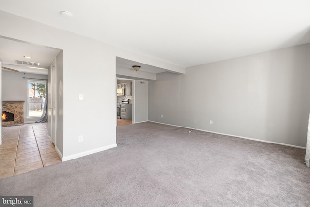 spare room featuring light colored carpet