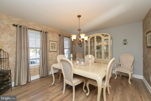 dining room featuring wood-type flooring and a chandelier