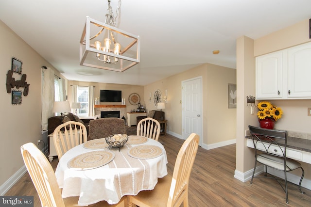 dining area with a notable chandelier and wood-type flooring