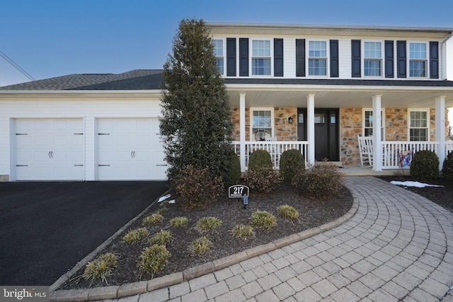 view of front facade featuring a porch and a garage