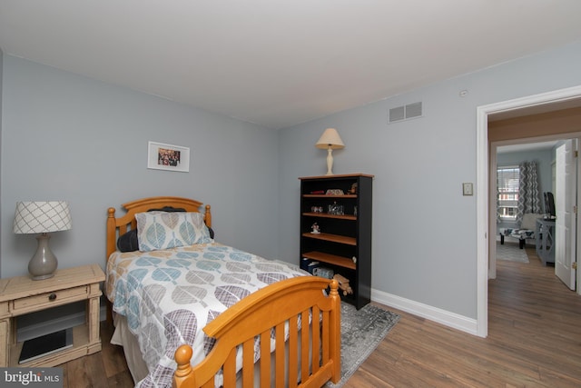 bedroom with dark wood-type flooring