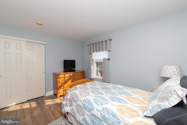 bedroom featuring hardwood / wood-style floors and a closet