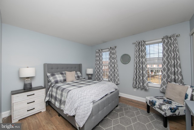 bedroom featuring dark hardwood / wood-style floors and multiple windows