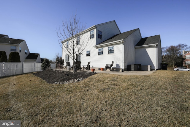 rear view of house featuring a yard and a patio area