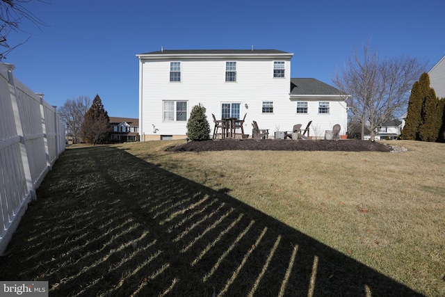 back of house featuring a yard