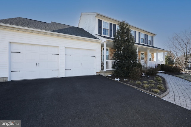 view of front of property with a garage and covered porch