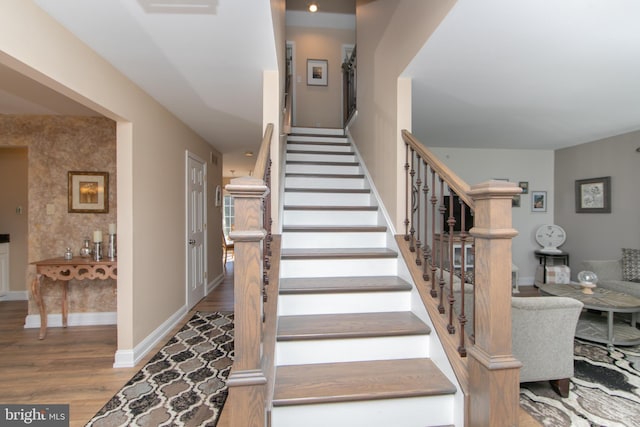 stairway featuring wood-type flooring