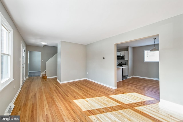 unfurnished living room with wood-type flooring