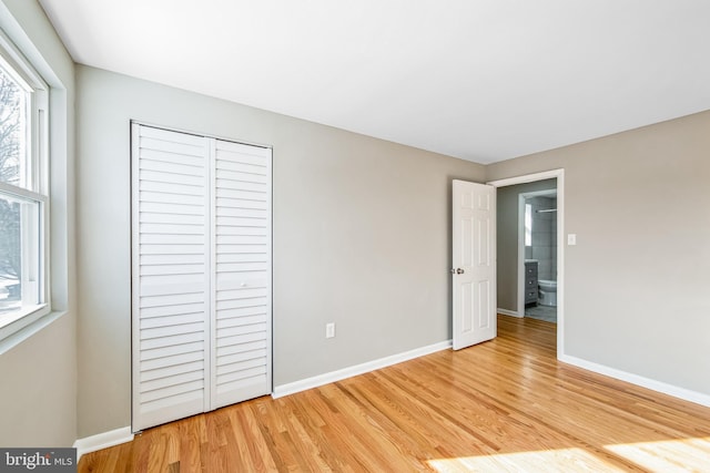 unfurnished bedroom featuring a closet and light hardwood / wood-style flooring