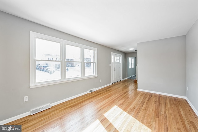 unfurnished living room featuring light wood-type flooring