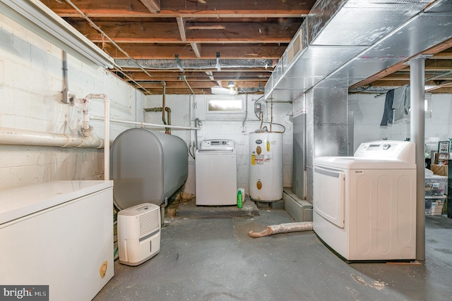 basement with gas water heater, washing machine and dryer, and refrigerator